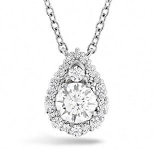 A teardrop halo diamond necklace features Hearts On Fire diamonds