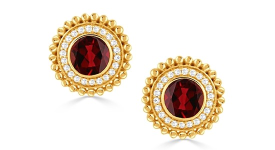 a pair of yellow gold stud earrings featuring red garnet and diamond accents