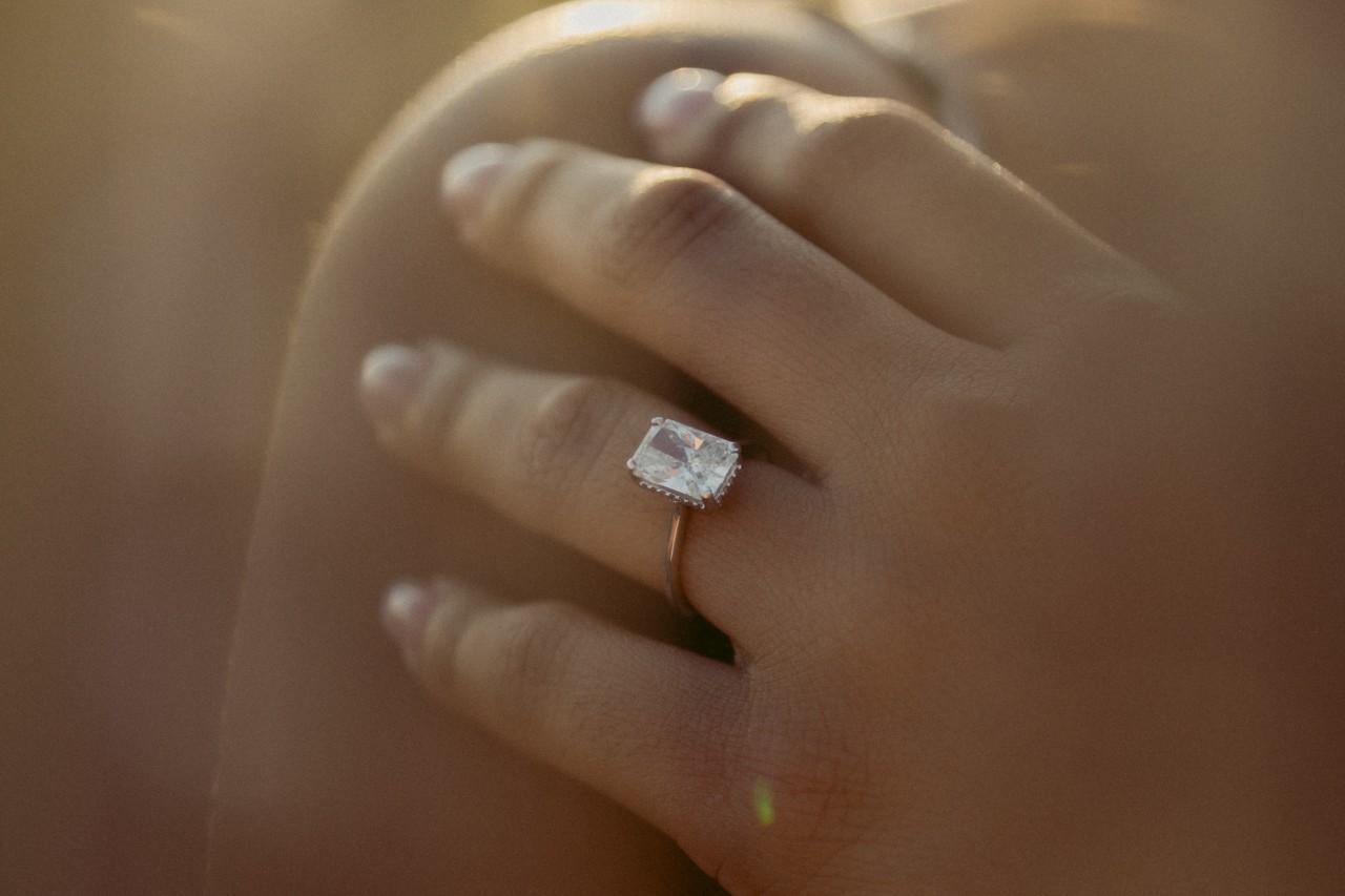 A close-up of a bride-to-be’s hand, adorned with a unique engagement ring.